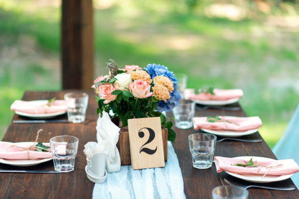 istock Table decoration with number. Elegant wedding table arrangement, floral decoration, restaurant. Wedding in the forest 1081976900
