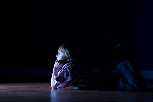 istock Little boy lays on the floor watching tv 108197813