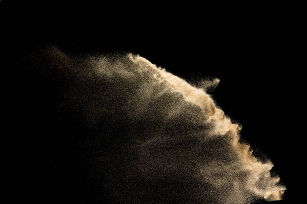 istock Golden sand explosion isolated on black background. Abstract sand cloud. 1081978858