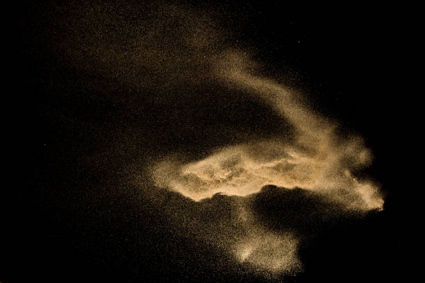 istock Golden sand explosion isolated on black background. Abstract sand cloud. 1081978958