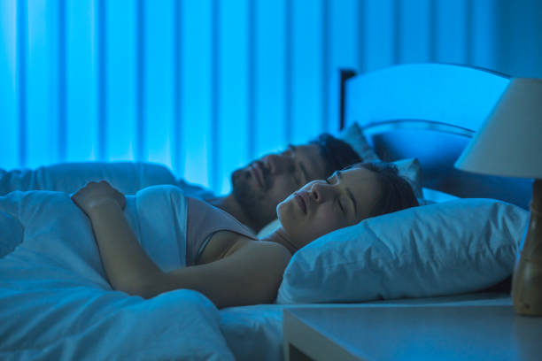 istock The sleeping man and woman on the bed. night time 1081979134