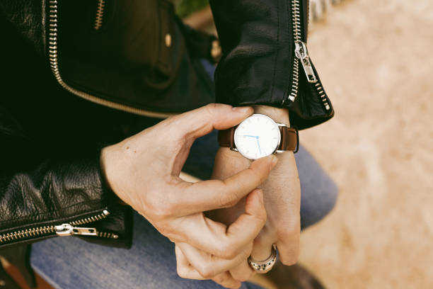 istock Hipster checking the time on his wrist watch. Closeup. 1081982364