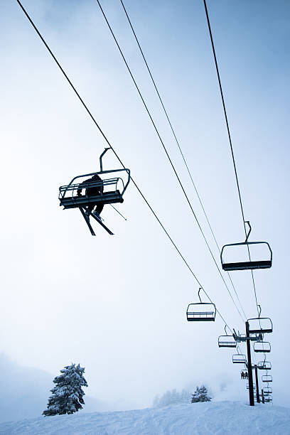 Dragobrat, Ukraine. March 18, 2024. In the morning there was severe frost in the village. everything was covered in thick fog, but people continued to ski and climb the mountains on the lifts