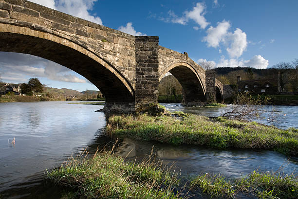 istock Stone Arch Bridge Across River on Sunny Day 108198316