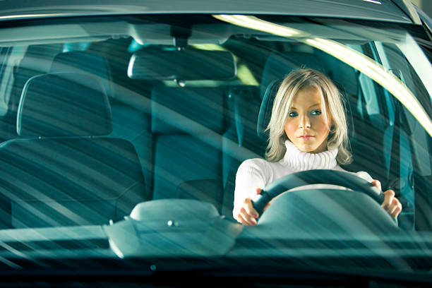 Portrait of Young Woman Driving Car stock photo