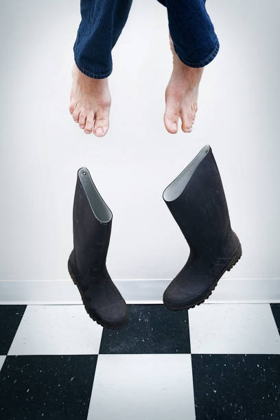Scared man flies right out of his shoes.  White background and black and white checkered floor.  Could symbolize fear, escape, super powers, the second coming of Christ (ie. the rapture ), etc.