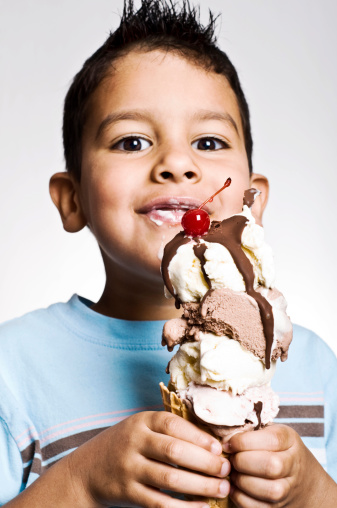 Child delighted with his enormous ice cream cone.