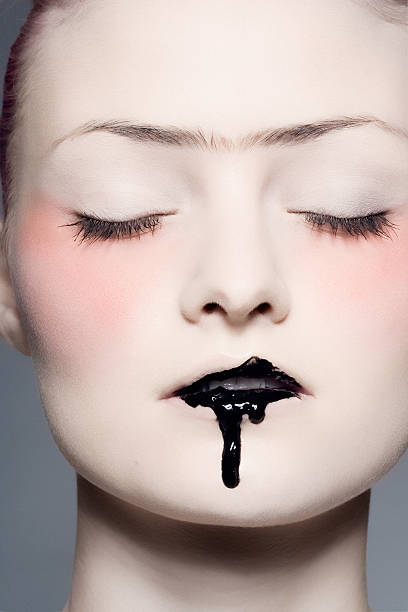 istock Young Woman Wearing Black Dripping Lipstick 108199048