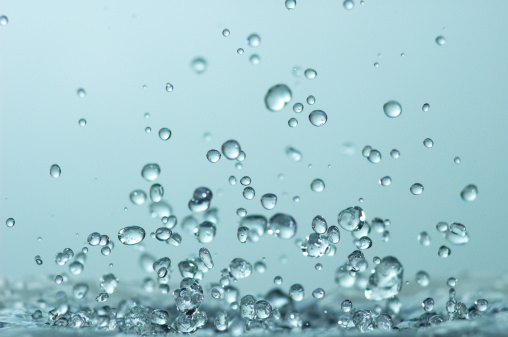 Many small bubbles flows over a color gradient background.