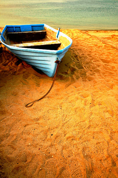 a blue wooden boat capture during sunset on a dubai beach[url=/file_closeup.php?id=6064388 t=_blank][img]/file_thumbview_approve.php?size=1&id=6064388[/img][/url]