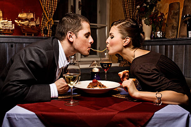 couple sharing single strand of pasta at dinner - foton med överkroppsbild bildbanksfoton och bilder