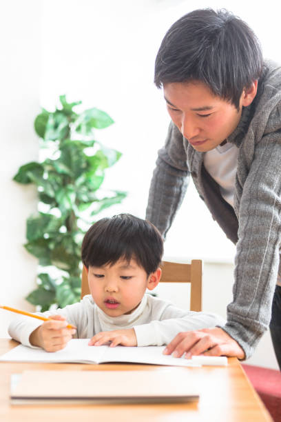 istock The child who studies and the parents who watch study 1081994650