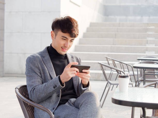 istock Portrait young business man smiling and using cell phone, typing and reading message or play mobile games, lifestyle concept. 1081995888