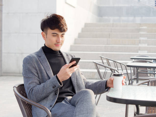 istock Portrait young business man smiling and using cell phone, typing and reading message or play mobile games, lifestyle concept. 1081996086
