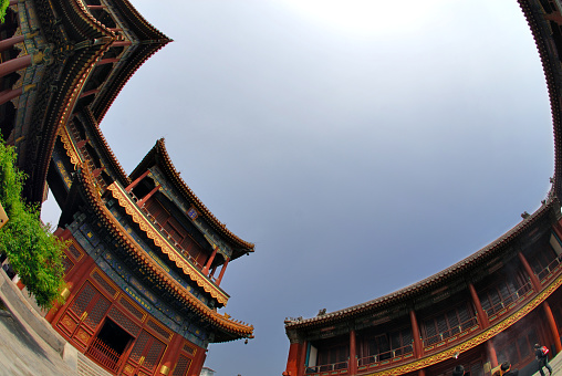 Typical oriental architecture in China. Unique aspect, wide angle, against the sun. Picture was made at Lama Temple, Beijing, China.