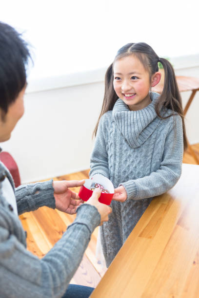 istock A daughter handing chocolates to her father 1081996570