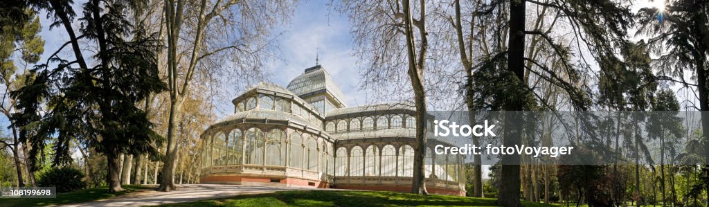 Retiro Park Madrid The delicate glass and wrought iron Palacio Cristal surrounded by the cool shade of the trees in the tranquil Parque del Retiro in the heart of Madrid, Spain. ProPhoto RGB color profile for maximum color gamut. Madrid Stock Photo