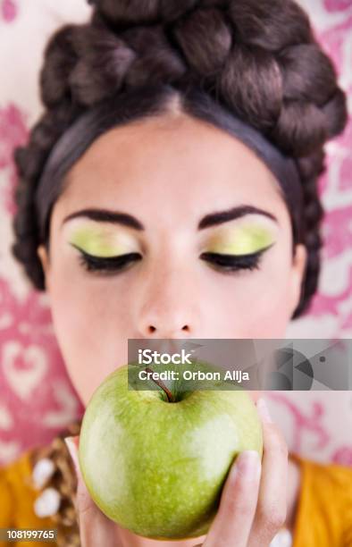 Young Woman Wearing Green Makeup Eating Apple Stock Photo - Download Image Now - Adolescence, Adult, Adults Only