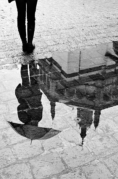 istock Reflection of Woman and Cathedral in a Puddle 108199803