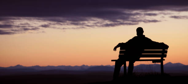 istock Silhouette of Man Sitting on bench at dusk 108200125