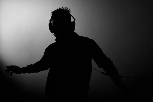 Silhouette of Man Dancing and Wearing Headphones  dj photos stock pictures, royalty-free photos & images