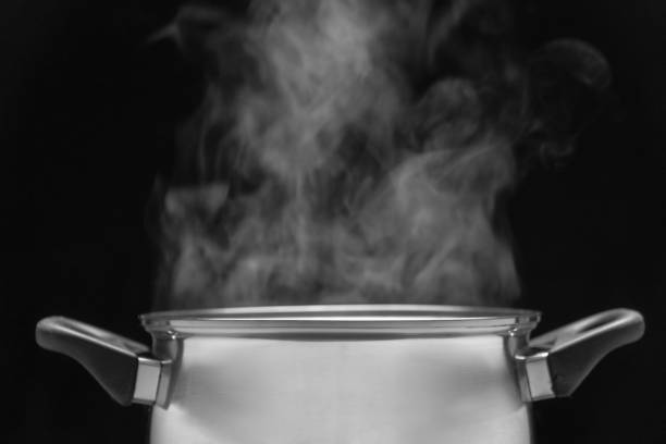 istock steam over cooking pot in kitchen on dark background 1082002122