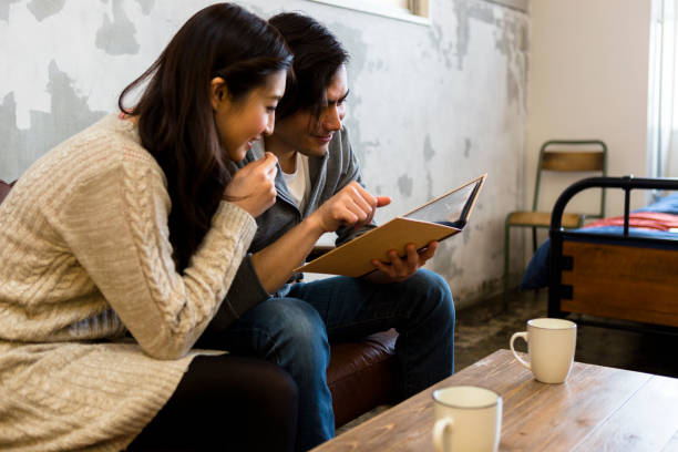 istock Young couple watching the album 1082002184
