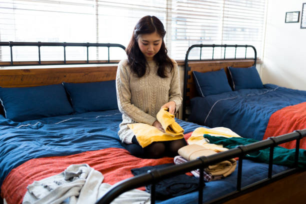 istock A woman who folds laundry 1082002380