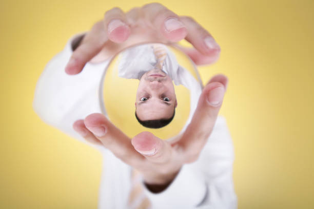 business prophecies businessman holding a globe and try to predict the future. business fortune telling. wide-angle. fortune teller photos stock pictures, royalty-free photos & images