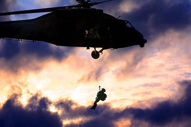 Military blackhawk helicopter rescuing a soldier stock photo