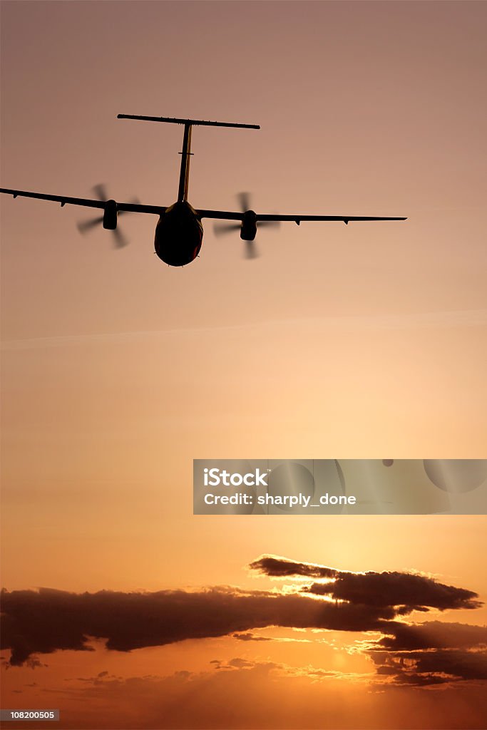 propeller airplane flying at sunset  Propeller Airplane Stock Photo