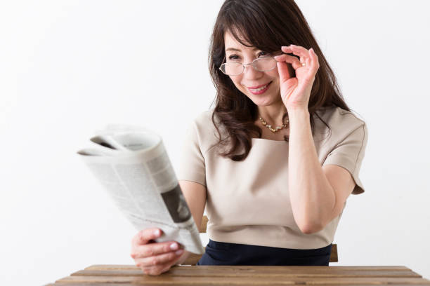 istock Middle woman reading a newspaper 1082005218