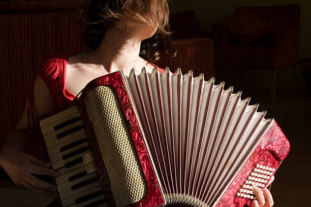 Close up of female playing red vintage accordion stock photo