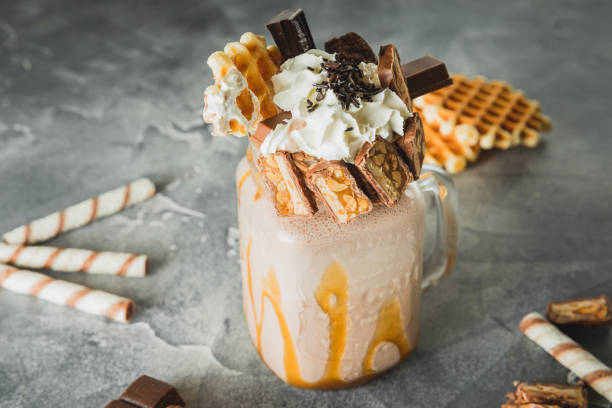 istock Sweet milkshake drink with dripping sauce, cream, cake and chocolate 1082006042