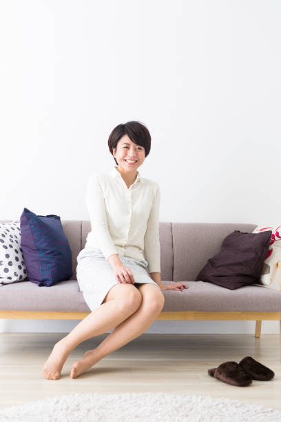 istock Woman sitting on the couch 1082006308