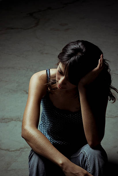 istock Sad Young Woman Sitting Concrete Floor 108200685