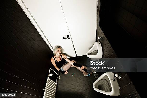 Young Woman Sitting In Restroom Injecting Drugs From Needle Stock Photo - Download Image Now