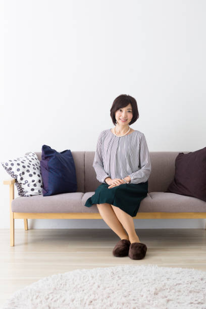 istock Middle woman sitting on the couch 1082008516