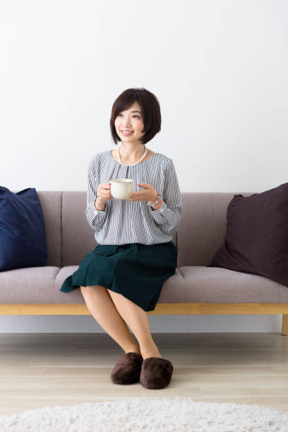 istock Middle woman sitting on the couch 1082008530