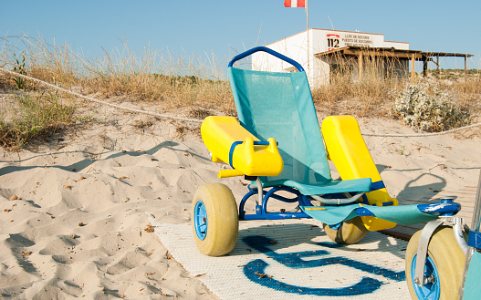 Wheelchair for the disabled and first aid station on the sandy beach