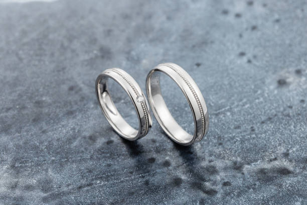 istock White gold or silver wedding rings on dark gray background 1082011738