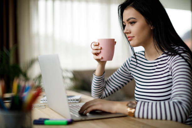 istock Young woman using laptop at home 1082011986