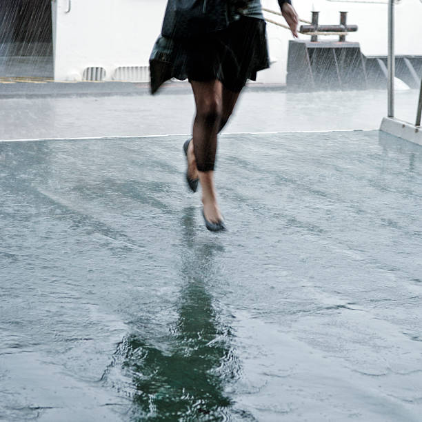 istock Woman's Legs Running Through Pouring Rain 108201394