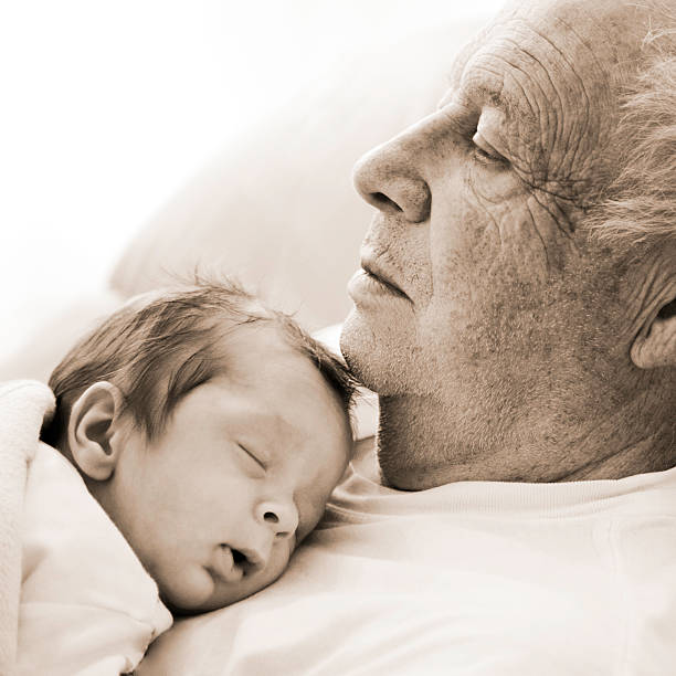 istock Sleeping Newborn Baby Lying on Senior Man's Chest 108201409
