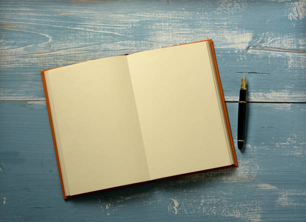 istock open book with blank pages on wooden table - closeup 1082014248