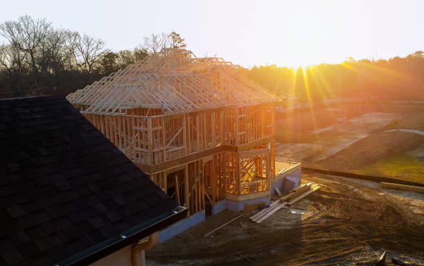 istock New residential construction house framing against a blue sky. 1082014284