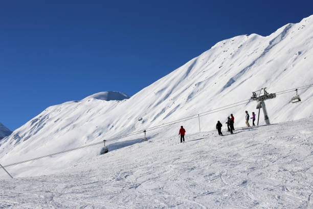 istock Skiers riding the slope 1082014744