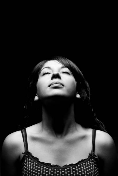 istock Young Woman Basking in Light Hitting Her Face 108201560