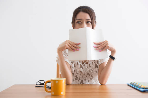 istock Women who hide their faces in books 1082018982