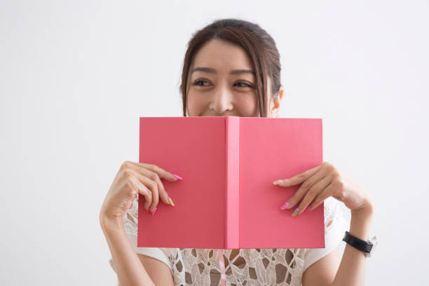 istock Women who hide their faces in books 1082019028
